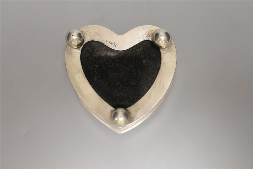 A late 19th/early 20th century Chines Export white metal mounted heart shaped pin cushion, by Zee Wo, width 64mm.